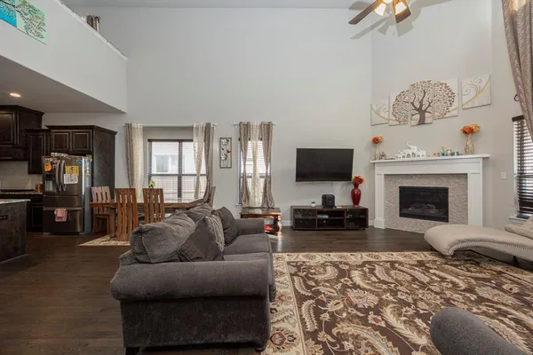 a living room with furniture a fireplace and a flat screen tv