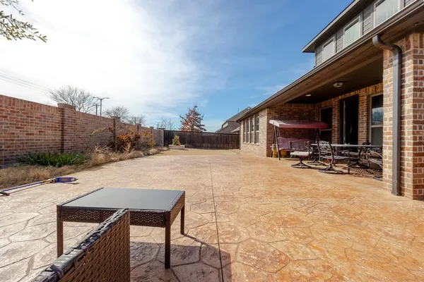 a view of house with backyard and sitting area