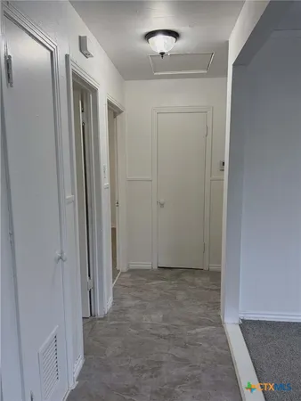 a view of an empty room with a window