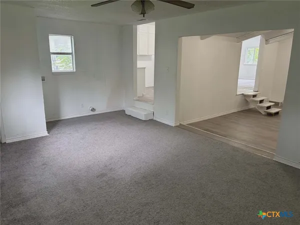 a white toilet sitting next to a white sink and vanity
