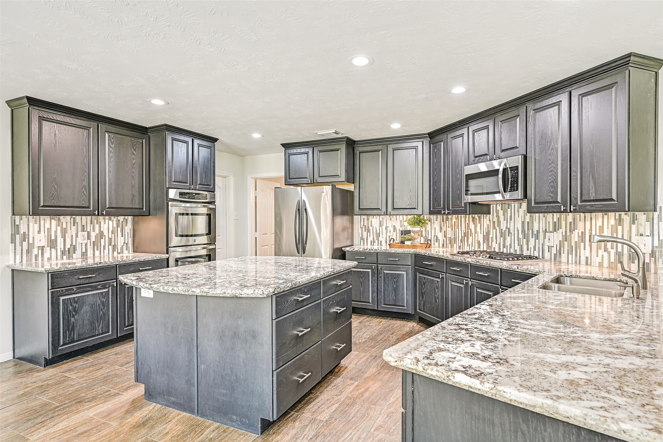 2015 Stonecrest Way Pearland, TX 77581 - Photo 14 of 26 a kitchen with stainless steel appliances granite countertop wooden cabinets a sink and dishwasher