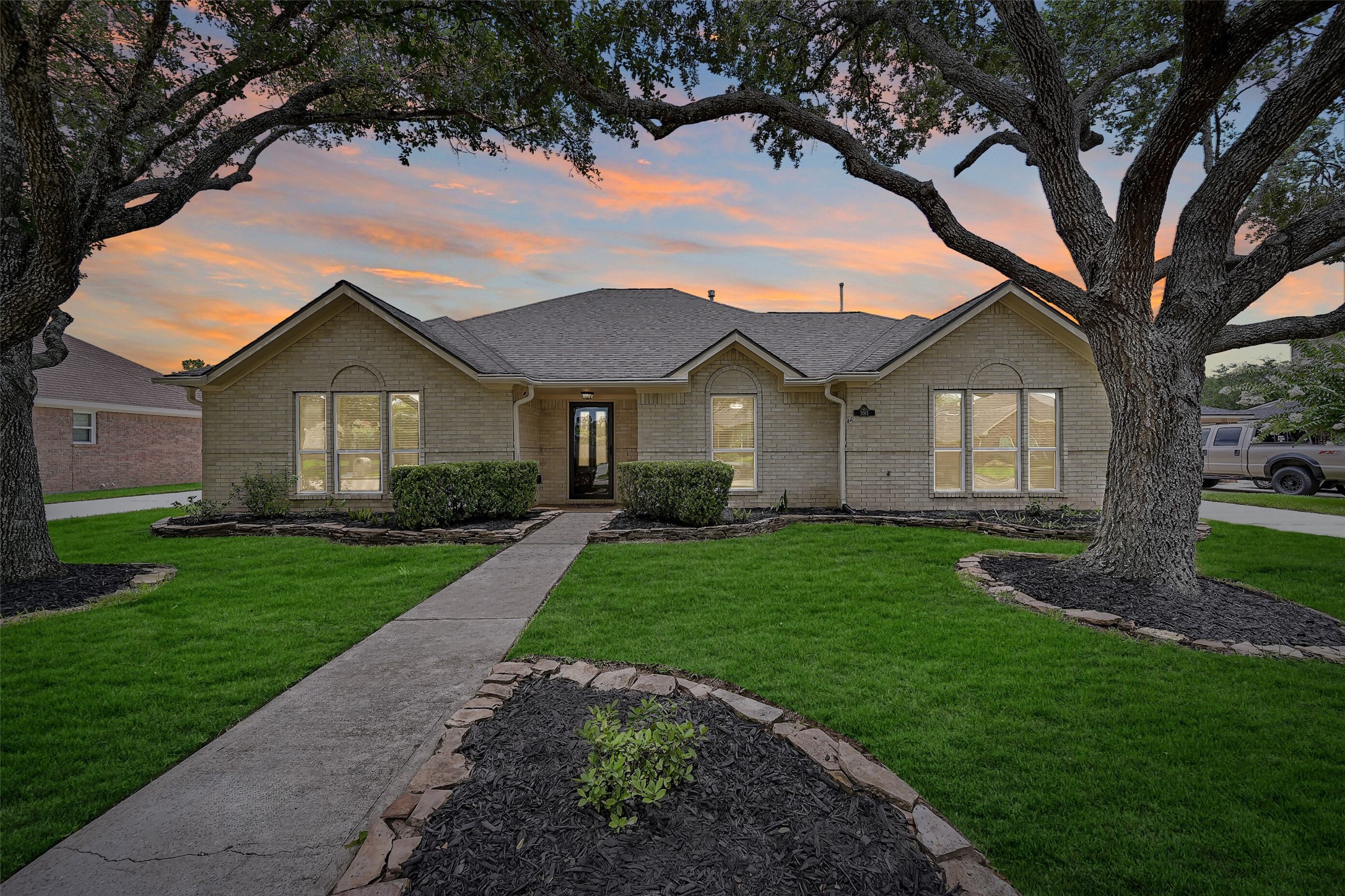 2015 Stonecrest Way Pearland, TX 77581 - Photo 2 of 26 a view of a yard in front of a house with plants and large tree