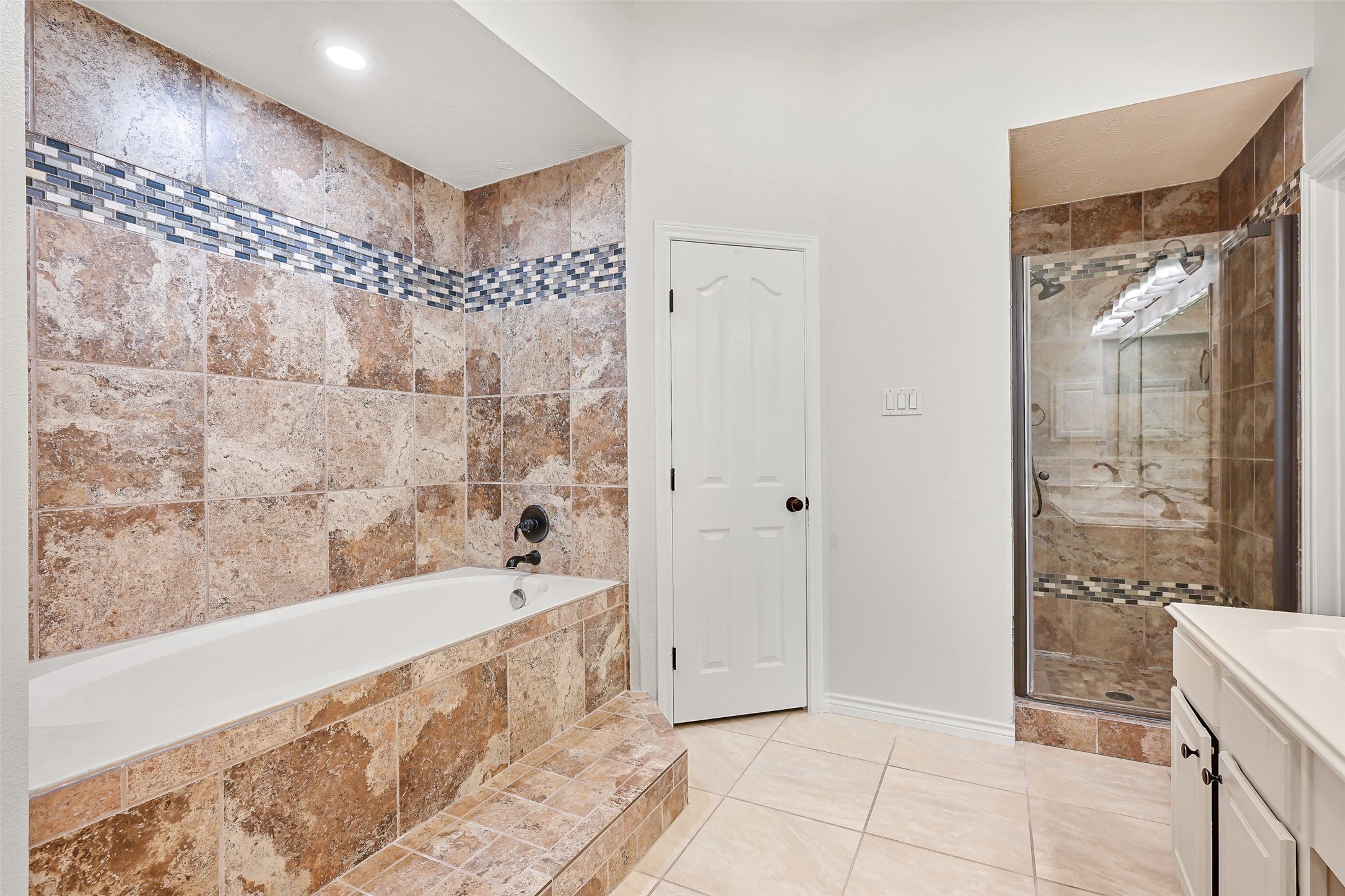 2015 Stonecrest Way Pearland, TX 77581 - Photo 22 of 26 a bathroom with a bathtub and a shower