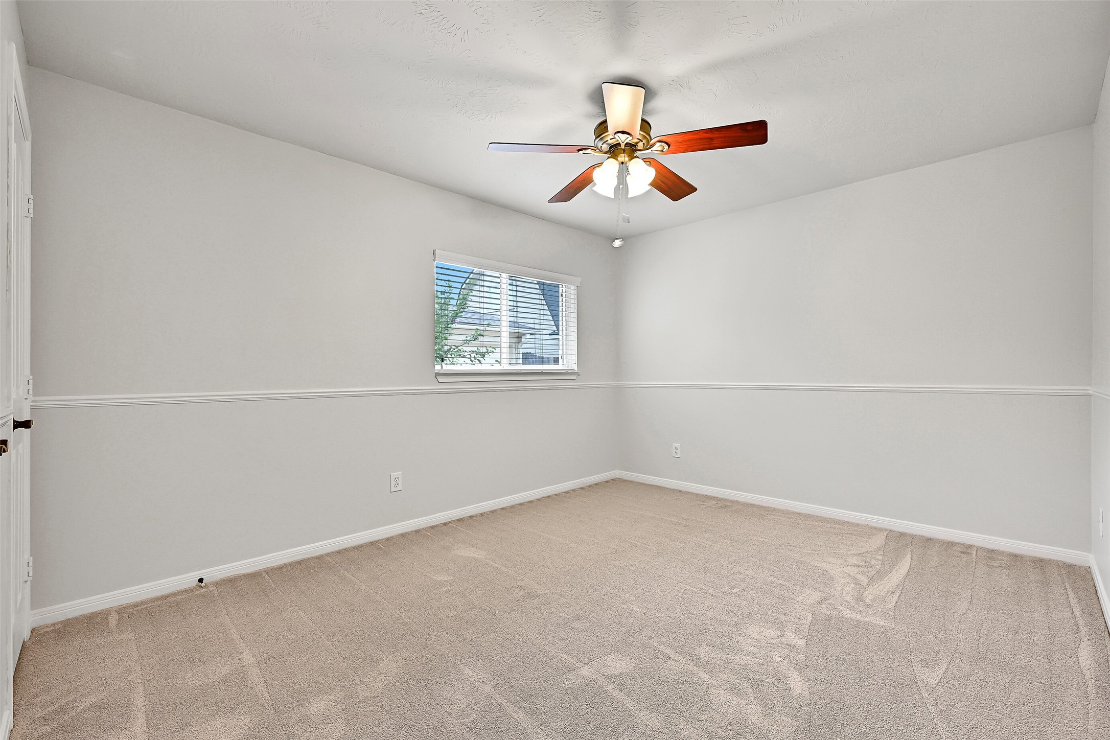 2015 Stonecrest Way Pearland, TX 77581 - Photo 23 of 26 an empty room with a window and a fan
