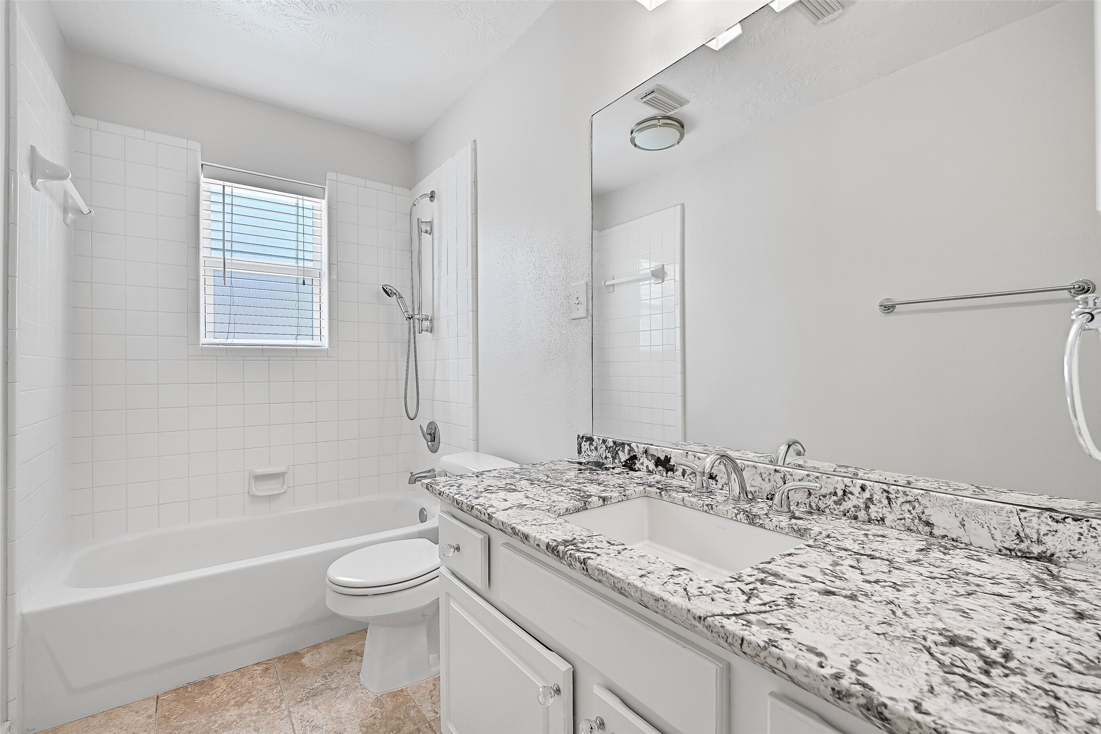 2015 Stonecrest Way Pearland, TX 77581 - Photo 24 of 26 a bathroom with a granite countertop sink toilet and shower