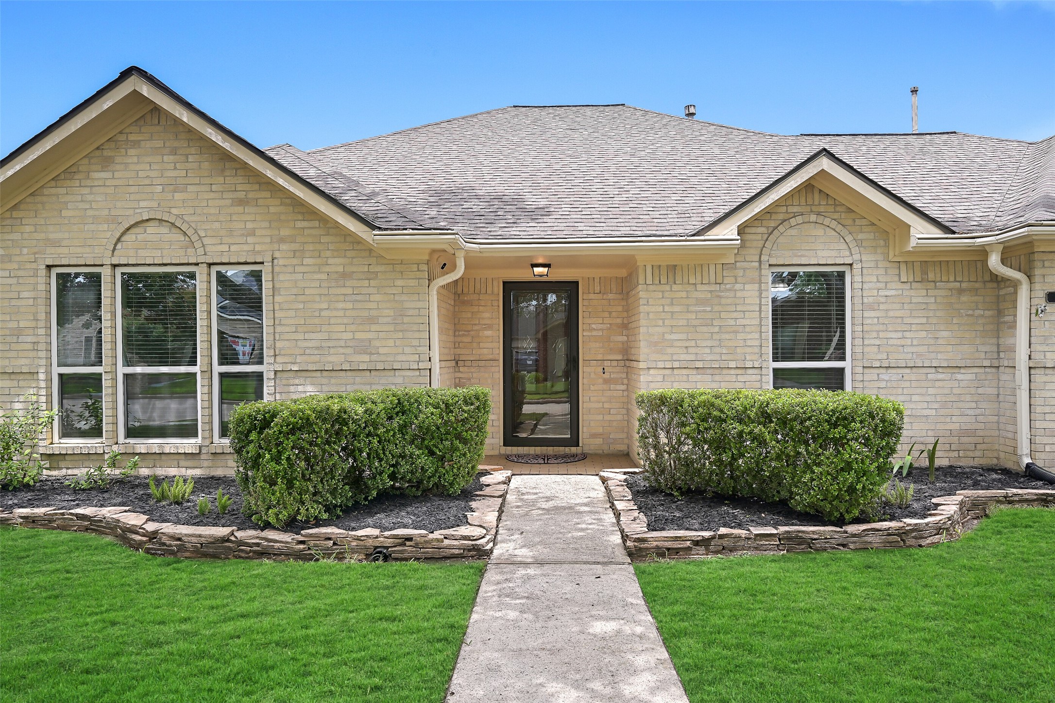 2015 Stonecrest Way Pearland, TX 77581 - Photo 4 of 26 a front view of a house with a yard and garage
