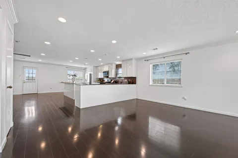 a view of a living room and kitchen with a large window