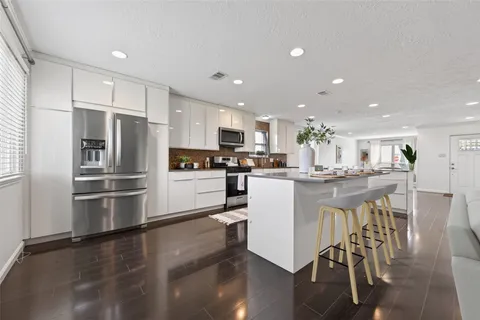 a living room with furniture kitchen and a fireplace
