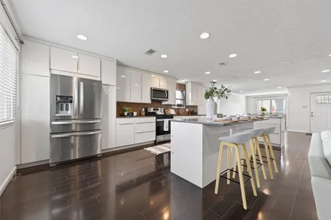a kitchen with a refrigerator and a sink