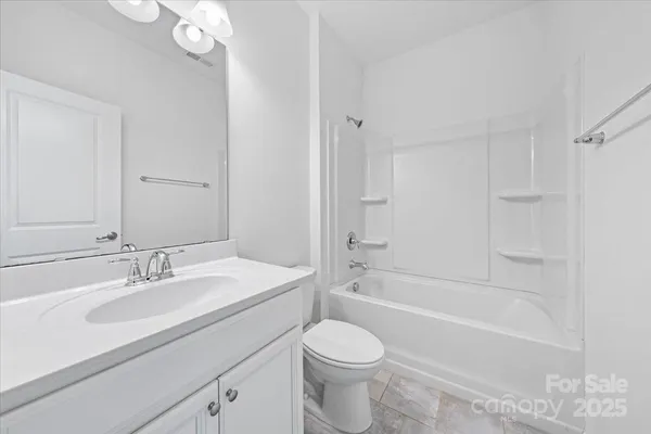 a bathroom with a sink a toilet and bathtub