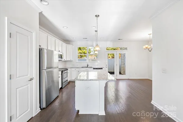 a kitchen with stainless steel appliances a refrigerator and a stove