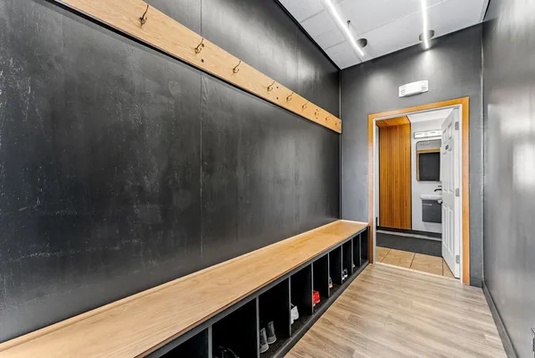 a hallway with wooden floor and stairs