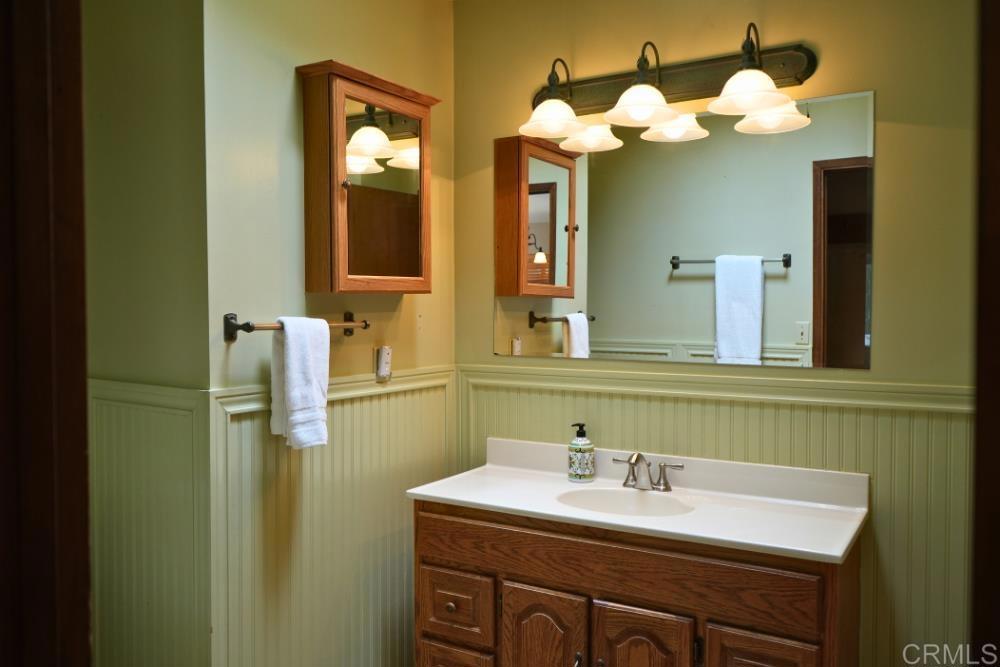 7192 Sandy Creek Road Julian, CA 92036 - Photo 15 of 64 a bathroom with a sink vanity and a mirror