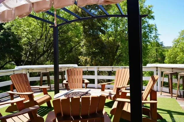 a view of staircase with lots of frames on wall and wooden floor