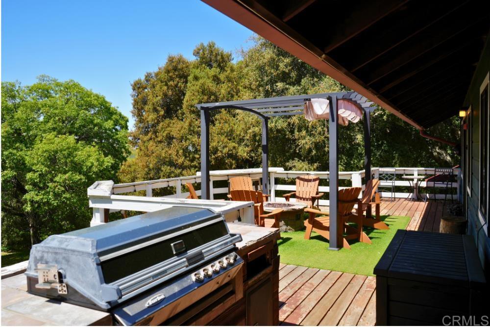 7192 Sandy Creek Road Julian, CA 92036 - Photo 22 of 64 a view of a patio with chairs and wooden floor