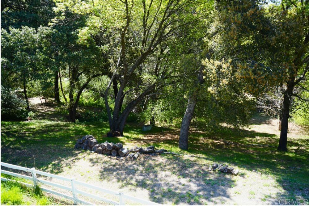 7192 Sandy Creek Road Julian, CA 92036 - Photo 24 of 64 a backyard of a house with lots of green space