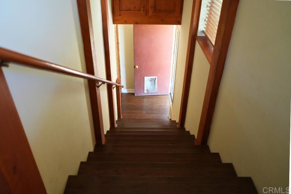 7192 Sandy Creek Road Julian, CA 92036 - Photo 25 of 64 a view of a hallway with wooden floor and staircase