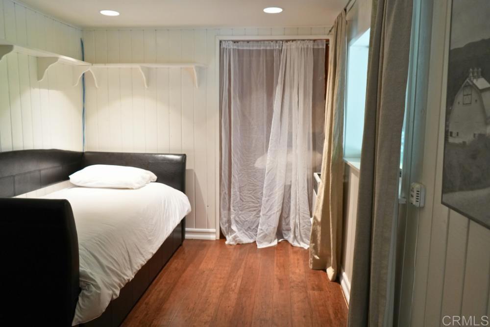 7192 Sandy Creek Road Julian, CA 92036 - Photo 30 of 64 a bedroom with a bed and a mirror