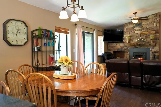 a view of a dining room with furniture a chandelier and wooden floor