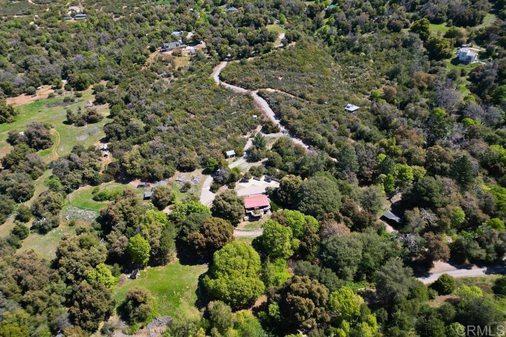 7192 Sandy Creek Road Julian, CA 92036 - Photo 56 of 64 a view of a house with a lush green forest