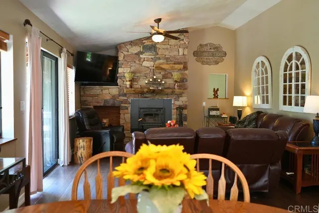 a living room with fireplace furniture and a window