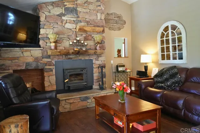 a living room with furniture a fireplace and a flat screen tv