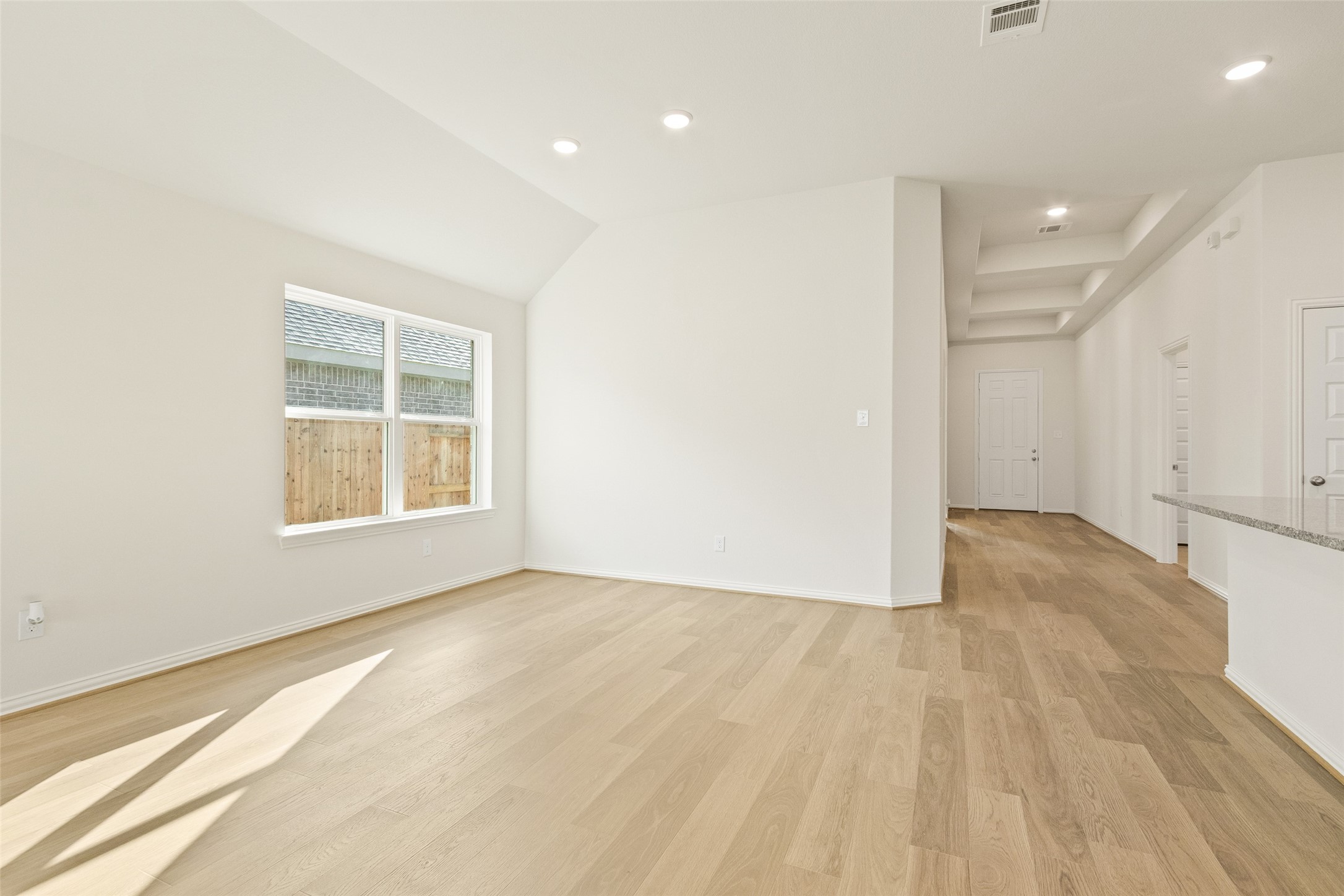431 Fields Forest Lane Dayton, TX 77535 - Photo 13 of 36 an empty room with wooden floor and windows