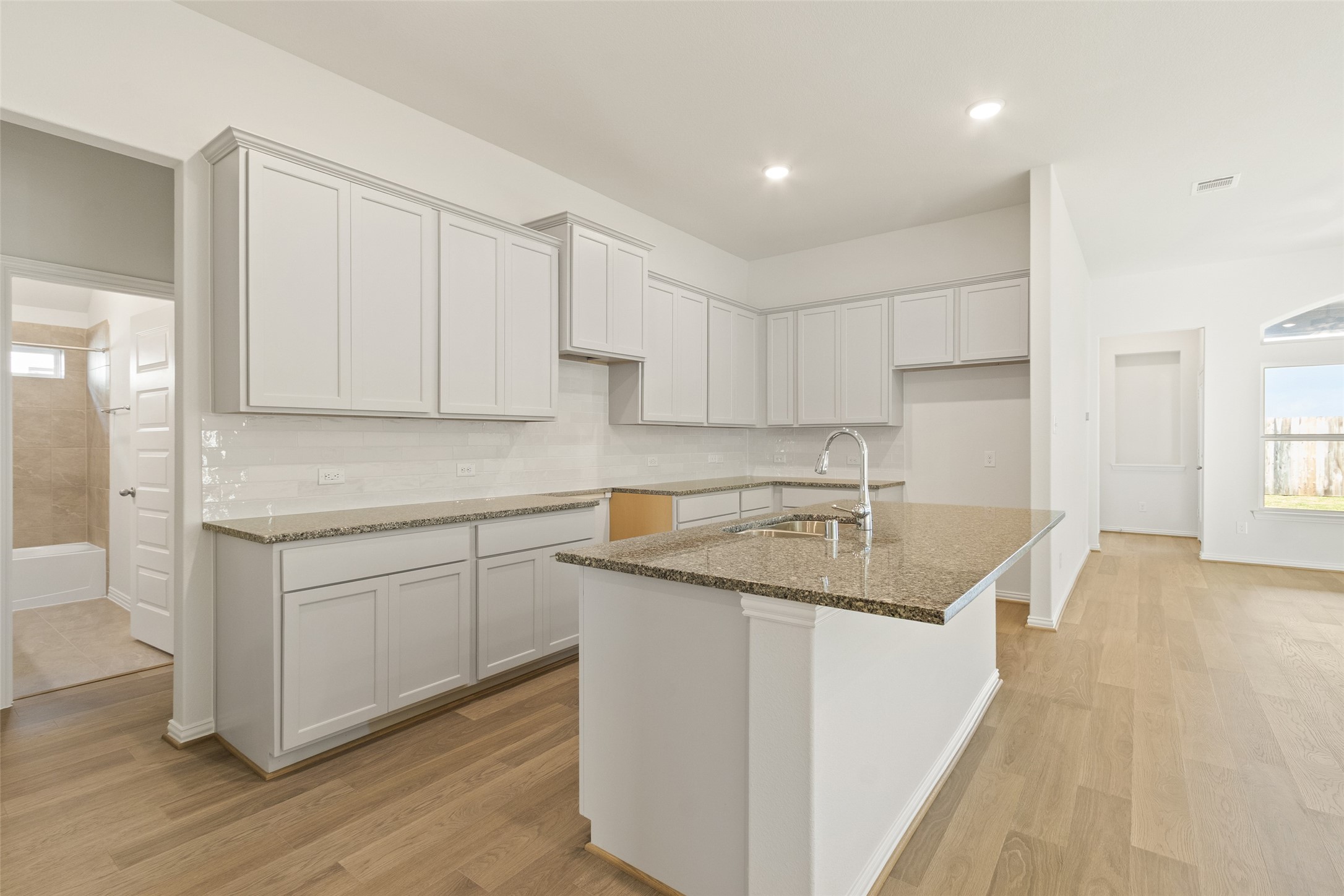 431 Fields Forest Lane Dayton, TX 77535 - Photo 6 of 36 a kitchen with a sink stove and cabinets
