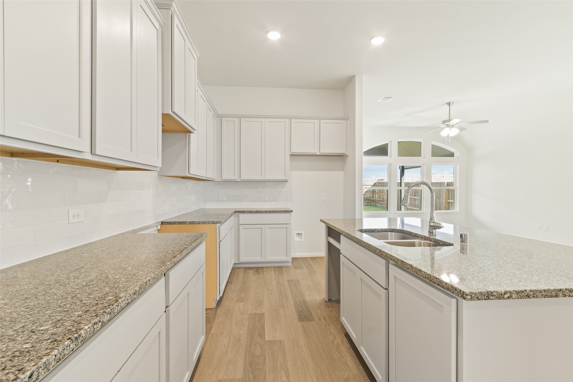 431 Fields Forest Lane Dayton, TX 77535 - Photo 7 of 36 a kitchen with granite countertop a sink and cabinets