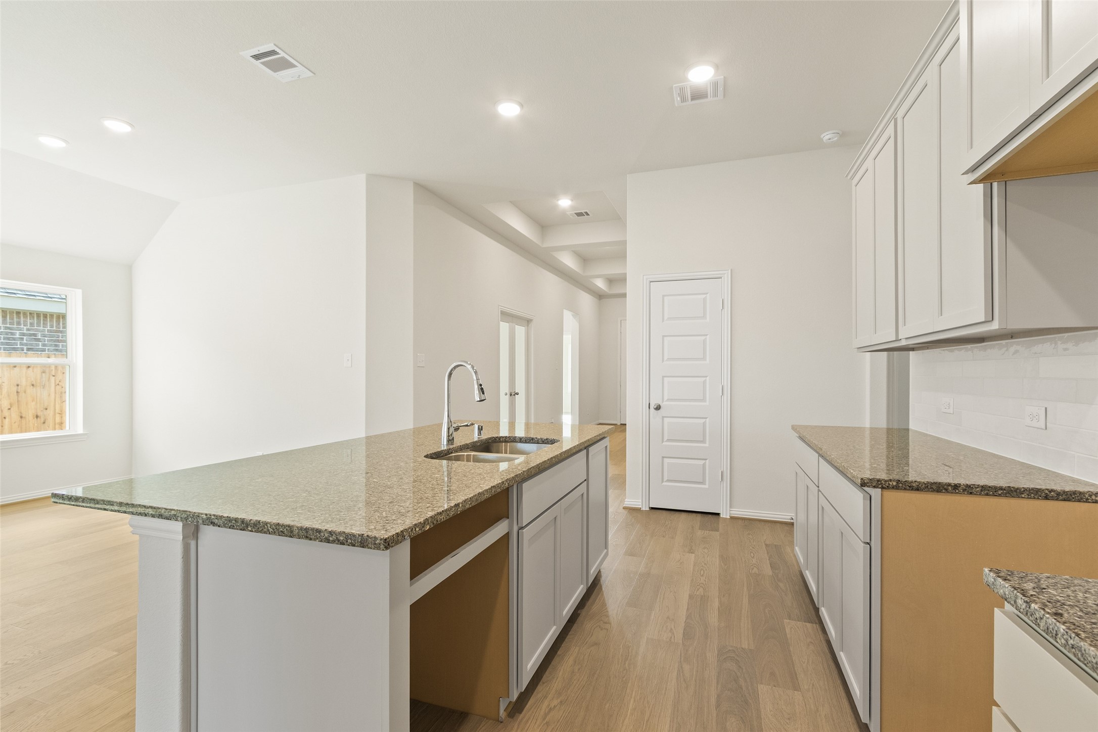 431 Fields Forest Lane Dayton, TX 77535 - Photo 8 of 36 a kitchen with granite countertop a sink stove and refrigerator