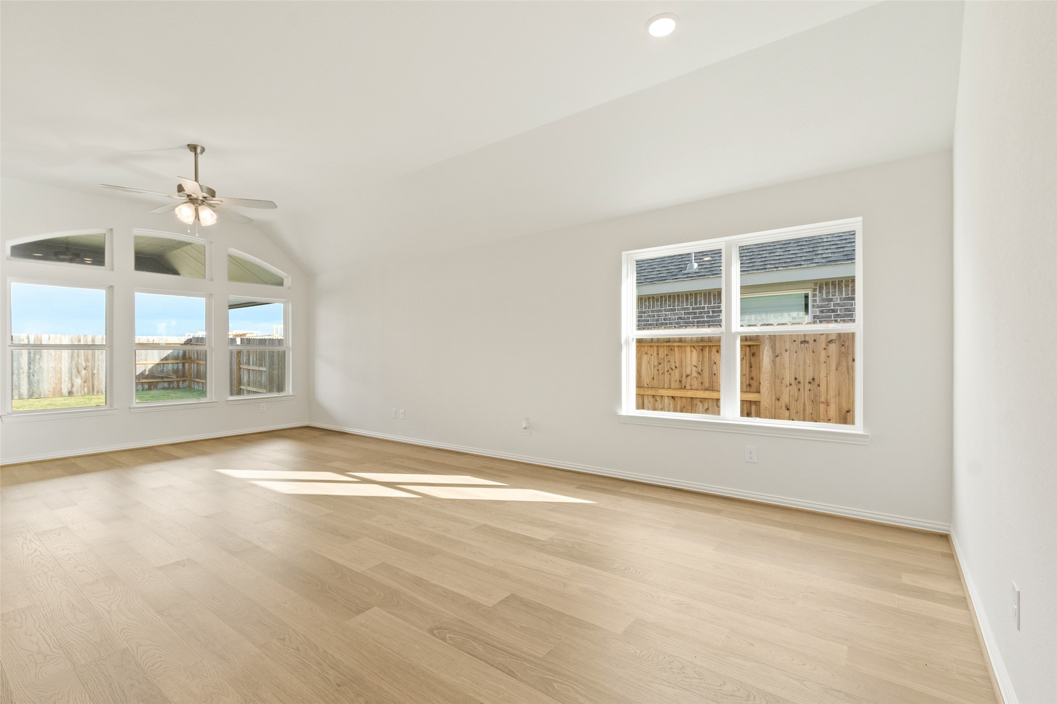 431 Fields Forest Lane Dayton, TX 77535 - Photo 10 of 36 an empty room with wooden floor and windows