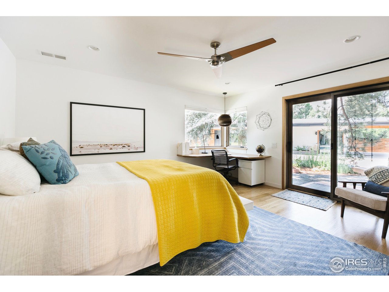 2600 West Prospect Road Fort Collins, CO 80526 - Photo 15 of 40 a bedroom with a bed and wooden floor