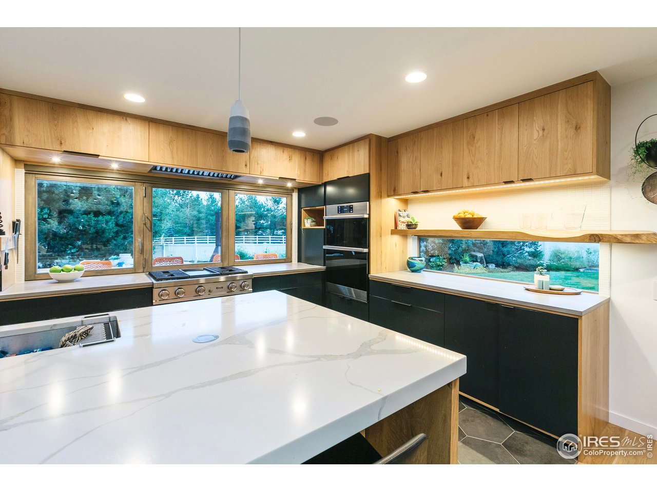 2600 West Prospect Road Fort Collins, CO 80526 - Photo 21 of 40 a kitchen with stainless steel appliances wooden cabinets a stove and a refrigerator