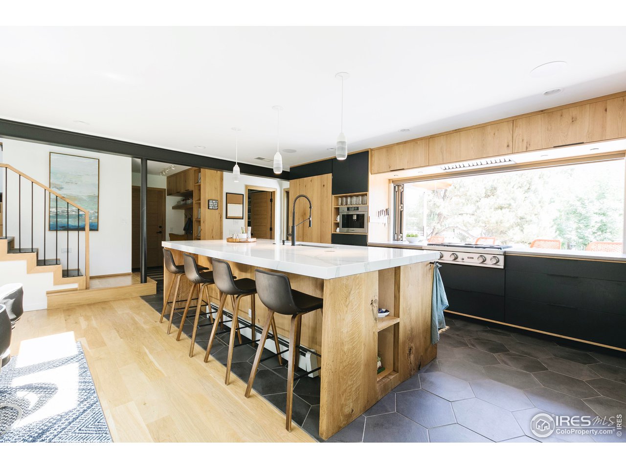 2600 West Prospect Road Fort Collins, CO 80526 - Photo 24 of 40 a living room with stainless steel appliances kitchen island granite countertop a sink and cabinets