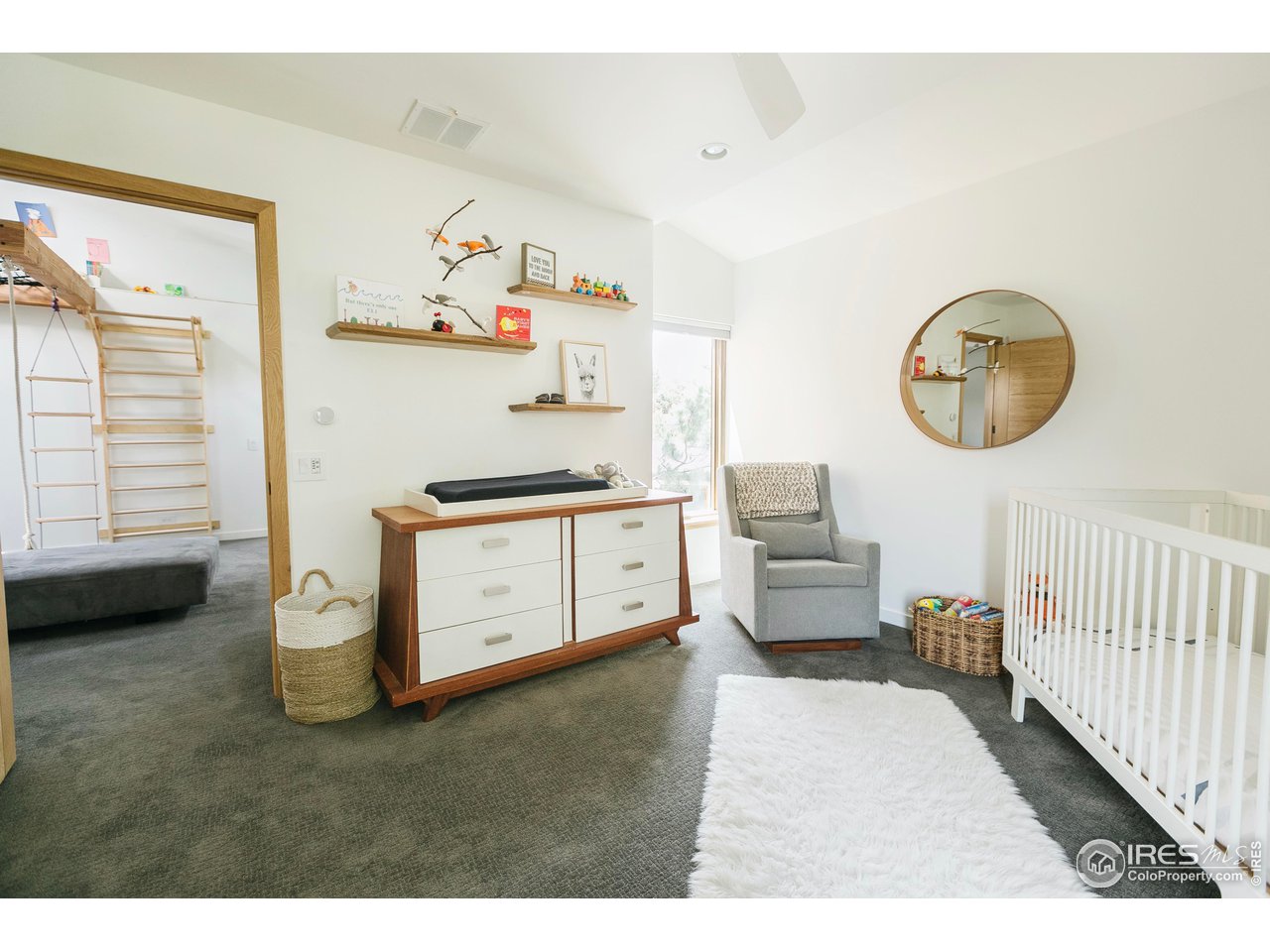 2600 West Prospect Road Fort Collins, CO 80526 - Photo 31 of 40 a bedroom with a bed and a chandelier