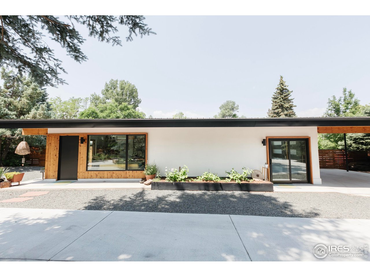 2600 West Prospect Road Fort Collins, CO 80526 - Photo 4 of 40 a view of a garden with a bench in front of building