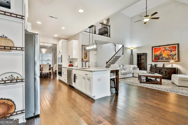 a kitchen with stainless steel appliances granite countertop a refrigerator and a stove top oven