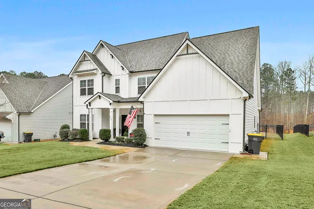 a view of a white house with a yard