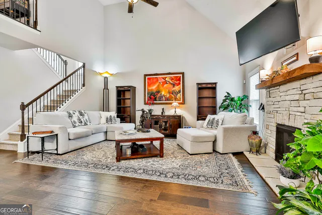 a living room with furniture a flat screen tv and a fireplace