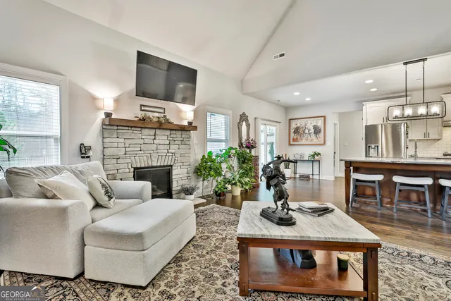 a spacious bedroom with a bed and a chandelier