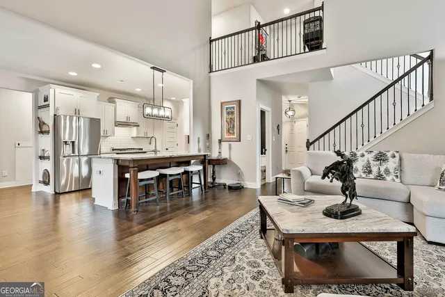 a spacious bedroom with a bed a dresser and chandelier