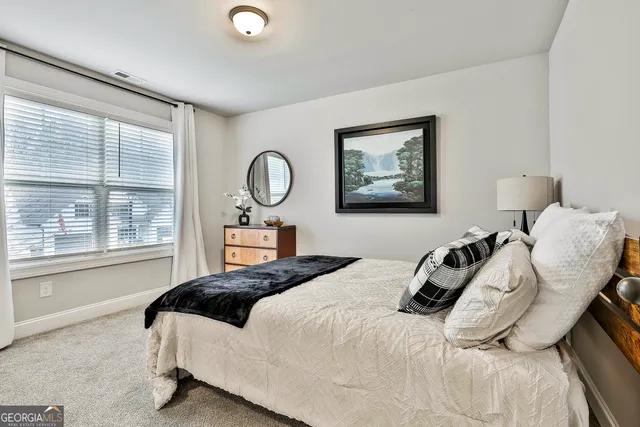 a spacious bedroom with a bed and a large window