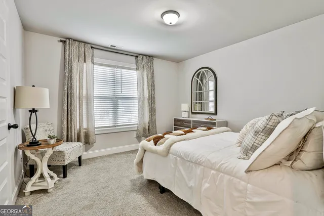 a work room with furniture and a large window