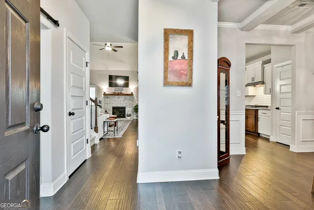 a view of walk in closet with hardwood floor and closet