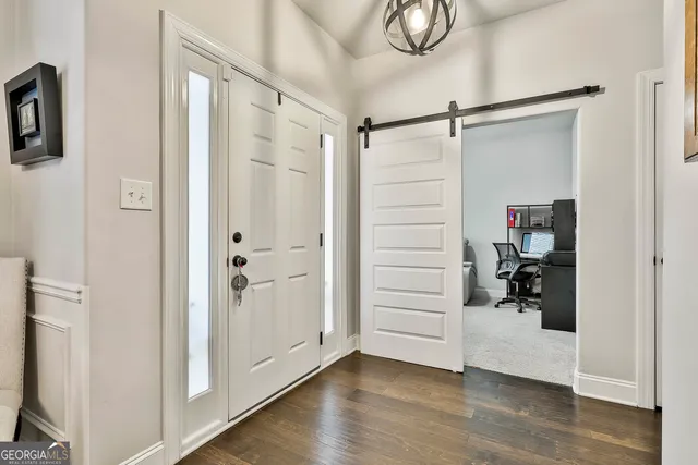 a view of a livingroom with workspace and a window