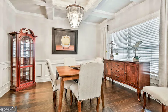 a view of a dining room with furniture a chandelier and wooden floor