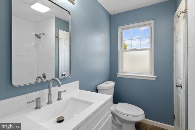 5477 Houghton Place, Unit 2 Philadelphia, PA 19128 - Photo 11 of 17 a bathroom with a sink a toilet and a mirror