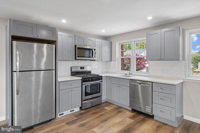 5477 Houghton Place, Unit 2 Philadelphia, PA 19128 - Photo 2 of 17 a kitchen with a refrigerator stove and sink