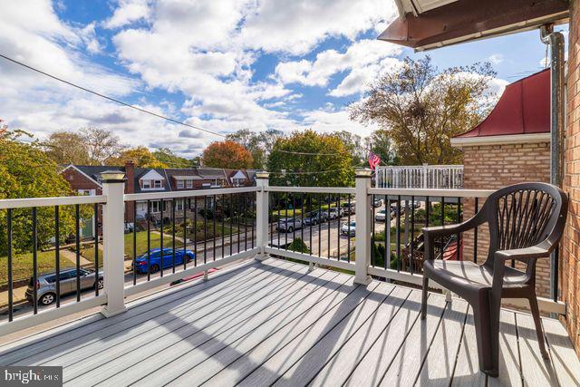 5477 Houghton Place, Unit 2 Philadelphia, PA 19128 - Photo 9 of 17 a view of a balcony with wooden floor and outdoor seating
