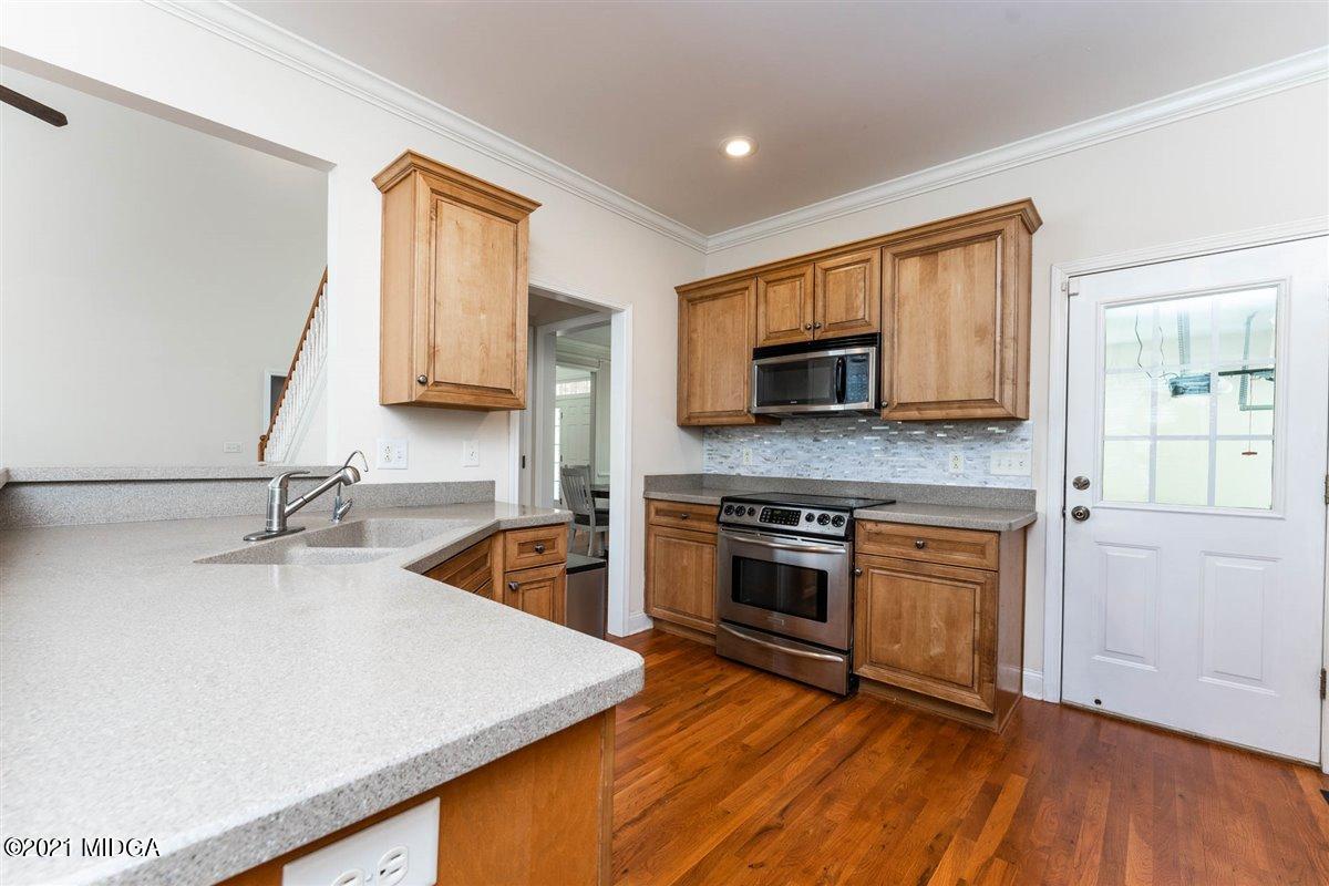 224 Carsons Walk Macon, GA 31206 - Photo 11 of 41 a kitchen with stainless steel appliances granite countertop a sink stove and microwave